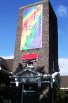 Grand Format Full Color Mesh Banner installed on side of Church on Capitol Hill | Seattle, WA