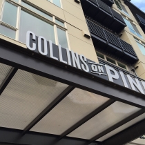 Main entrance sign for Collins on Pine apartments in Seattle, Washington. Dimensional letters &amp; aluminum backer plate.