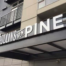Solid ½” thick aluminum dimensional letters installed on a ¼ in aluminum backer panel in Seattle, Washington