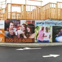 Large mesh banner attached to construction fence in Renton Washington