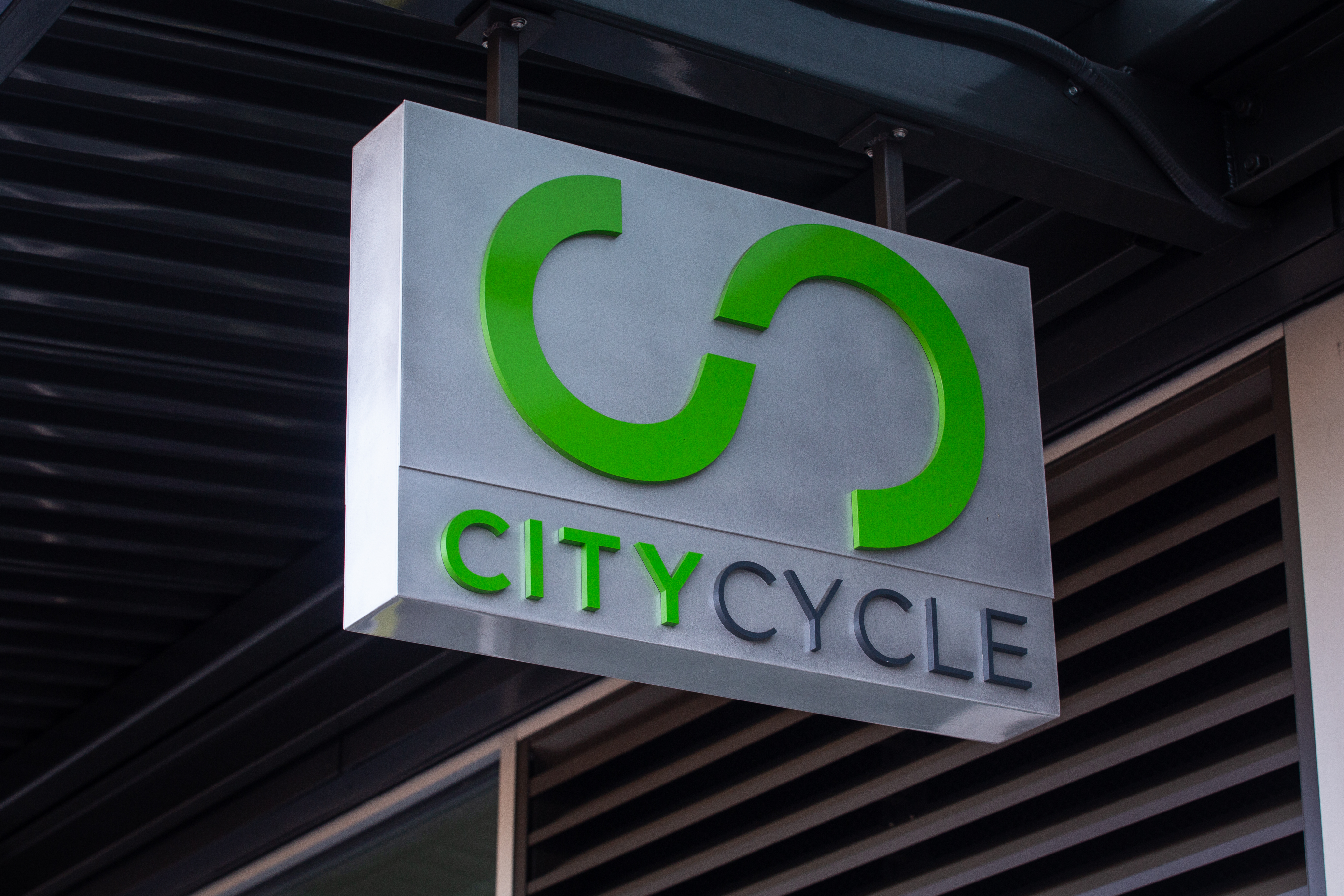 Brushed Aluminum Blade Sign that reads City Cycle