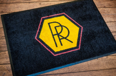 Logo carpet rug with non-slip rubber back.
